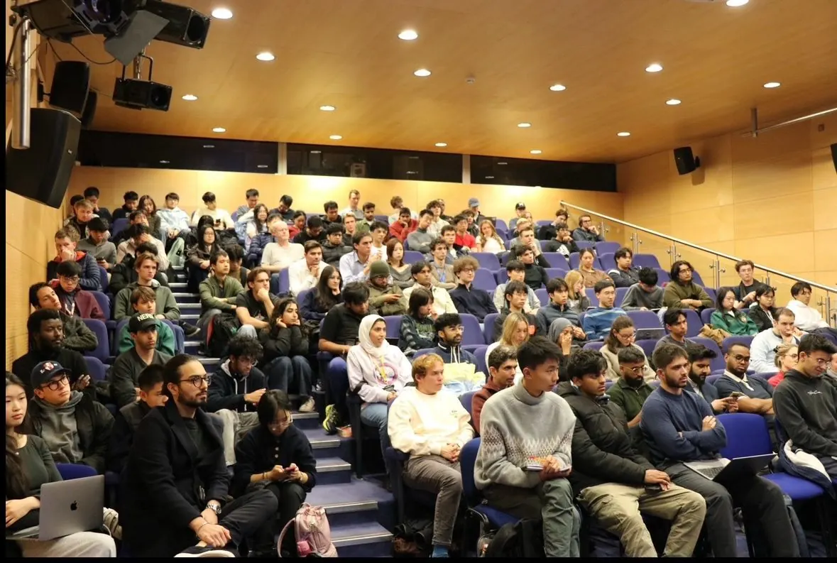 A full lecture theatre of students and guests at the fireside chat with James He.