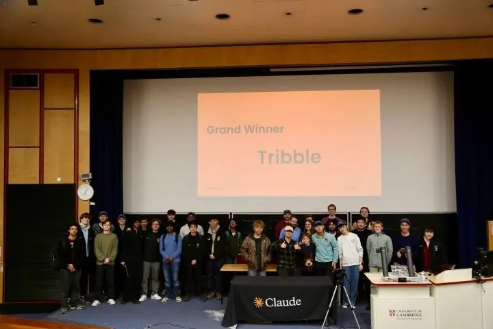 A team on stage at the Claude AI hackathon in Cambridge.