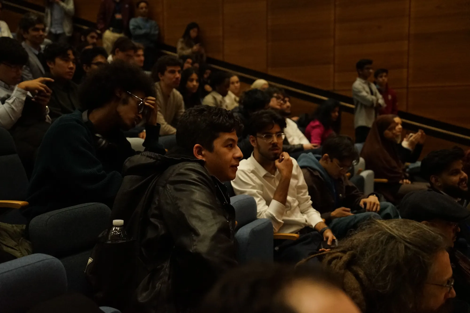 Students in the middle rows of a lecture hall at King's College London, listening to a talk.