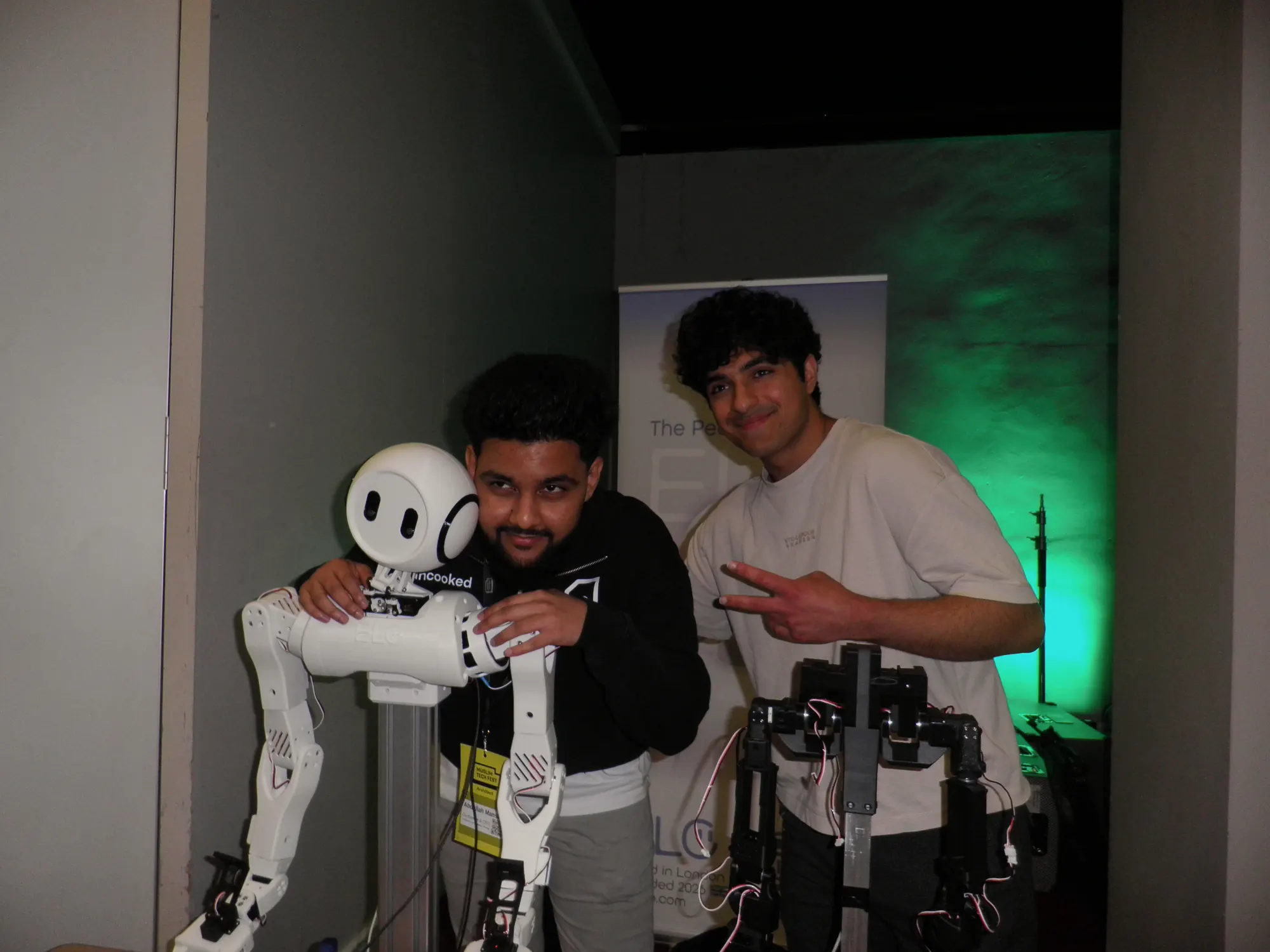 Two people with the Elo humanoid robot.