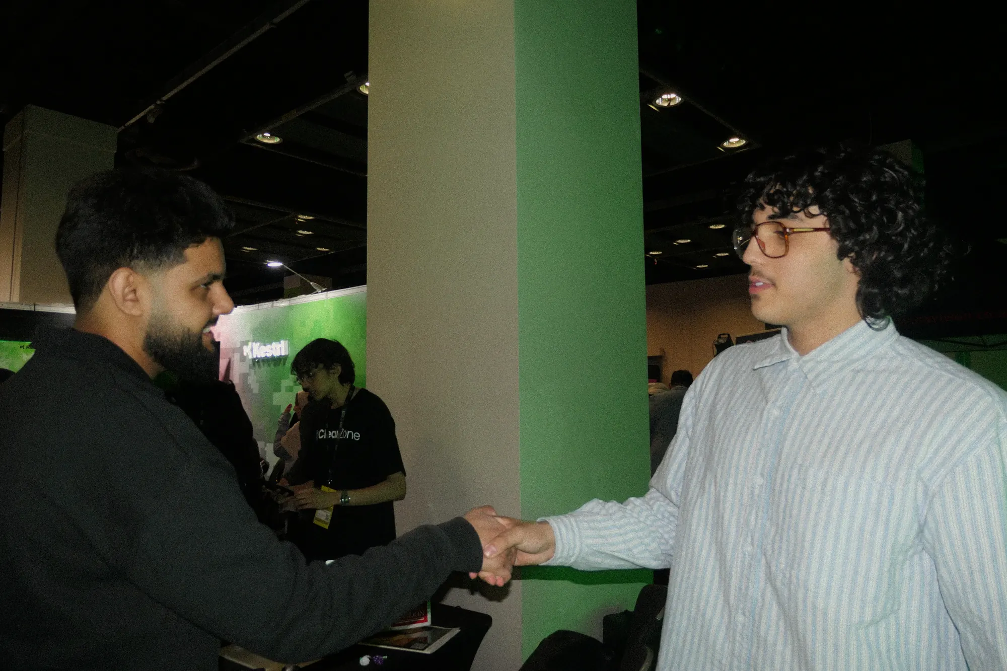 Two people shaking hands at the event.