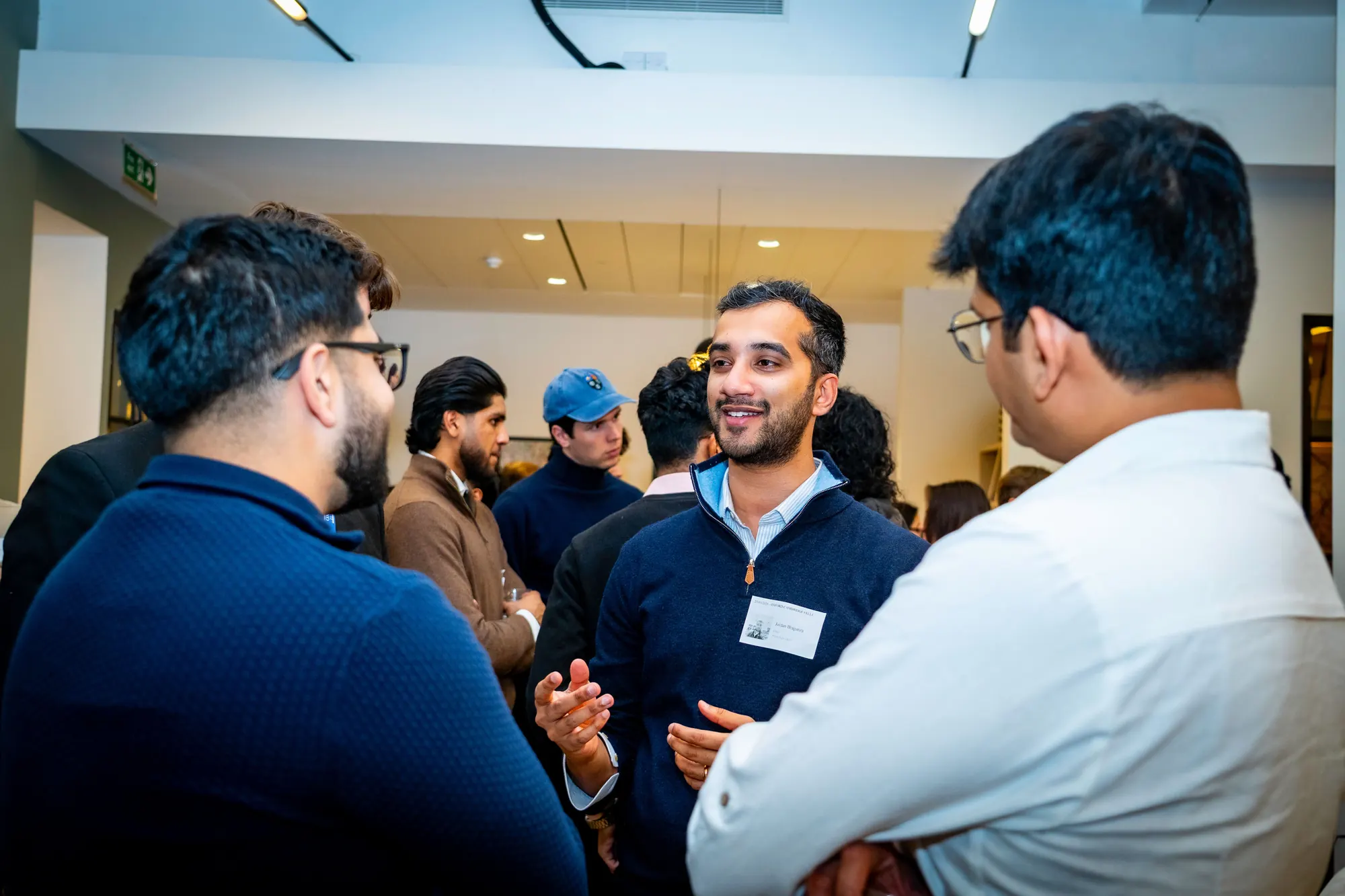 Guests in conversation at the Oxford Cambridge Fellowship mixer at Barclays Eagle Labs.