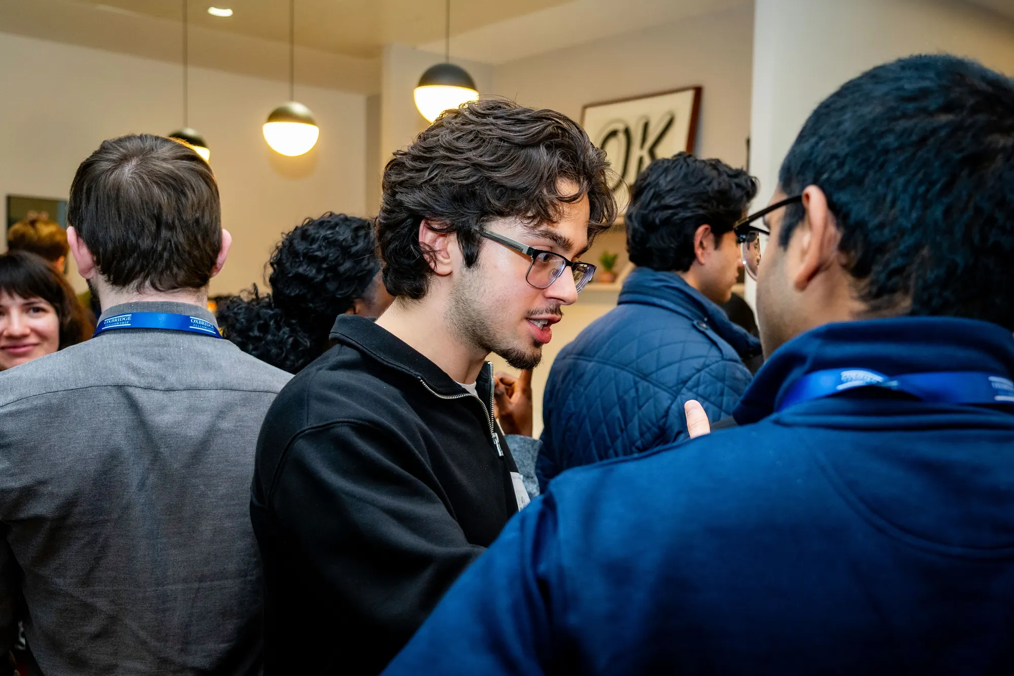 Guests in conversation at the mixer.